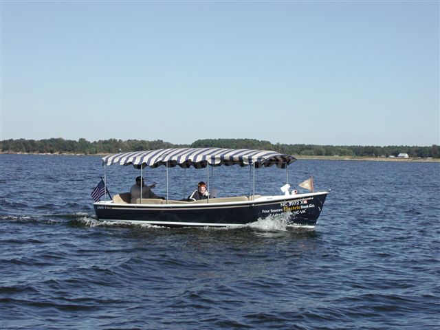 electric boat landing four seasons electric boats at dockside landing on lake electric boat landing four seasons electric boats at dockside landing on lake
